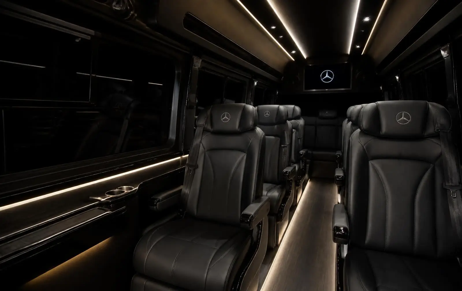 Interior of a TSPVIP VIP Sprinter: leather captain seats and ambient lighting